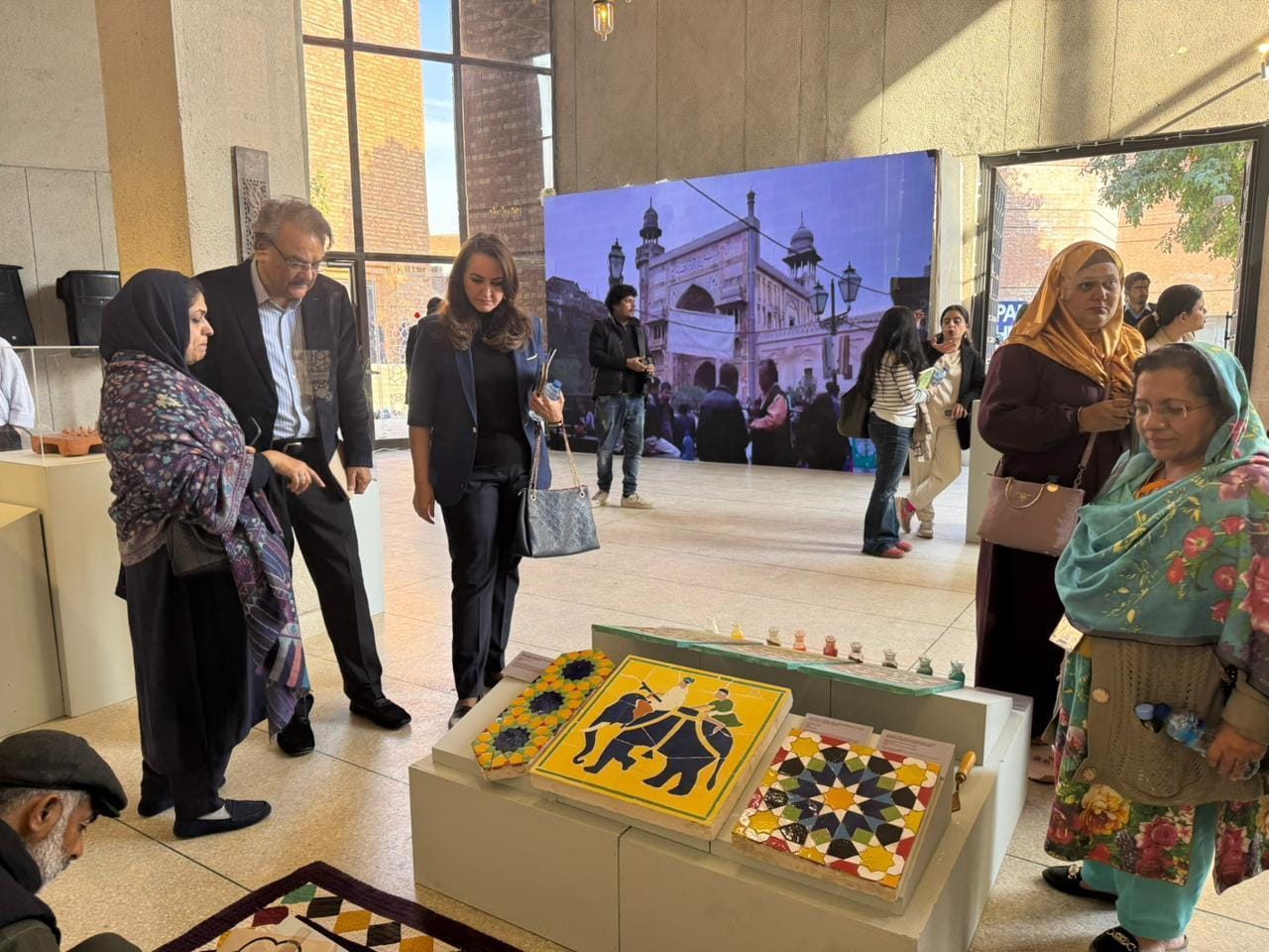 Exhibition view featuring Naqqashi and Kashi Kari panels.