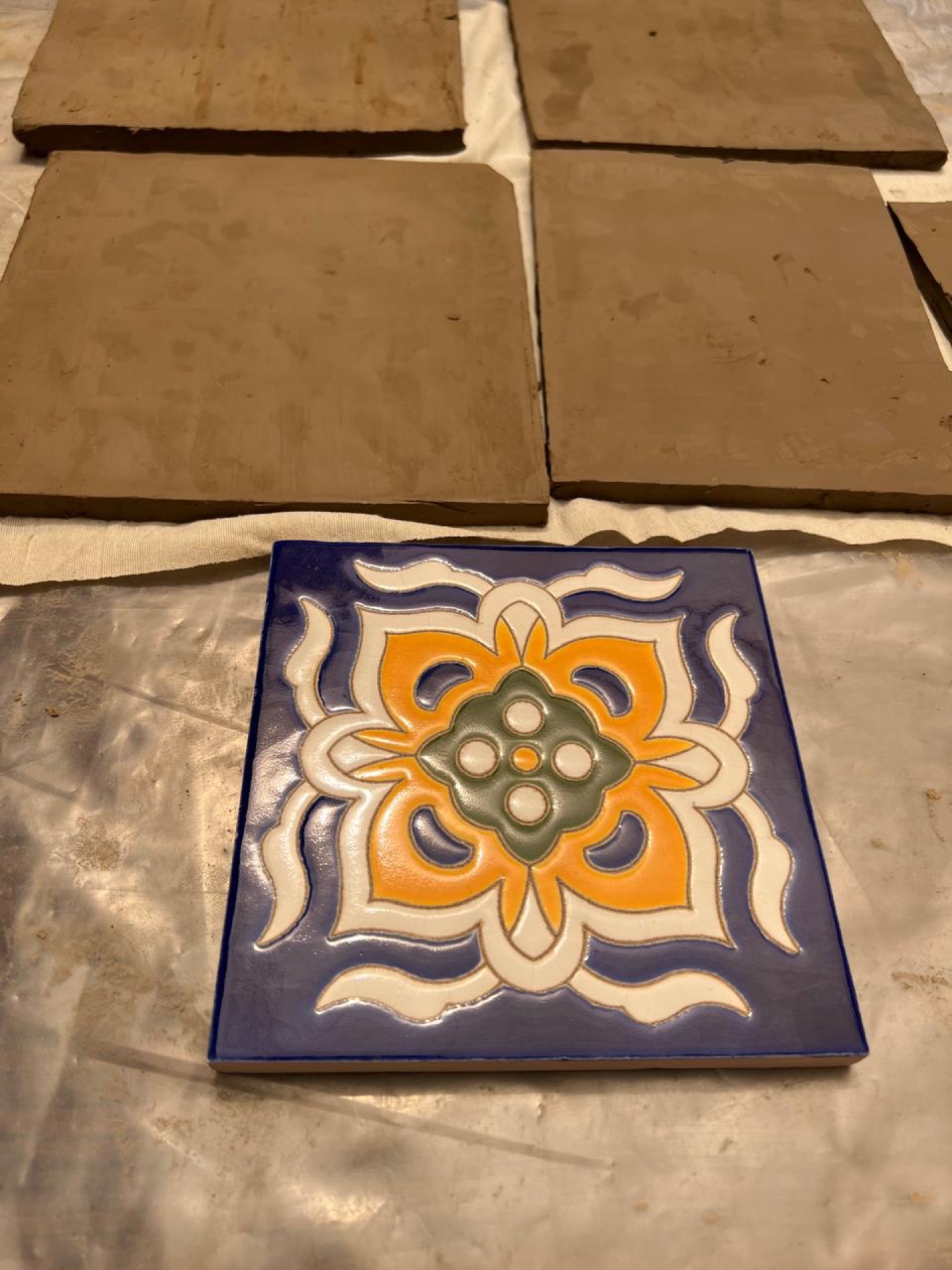 Kashi Kari hands-on practice with Kashi Kari Experts Amjad Daudpota, Taimoor Daudpota and Arsalan Daudpota — brush painting traditional Sozenkari patterns on tiles.